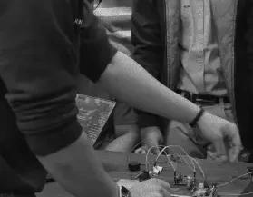 Students wiring a circuit board