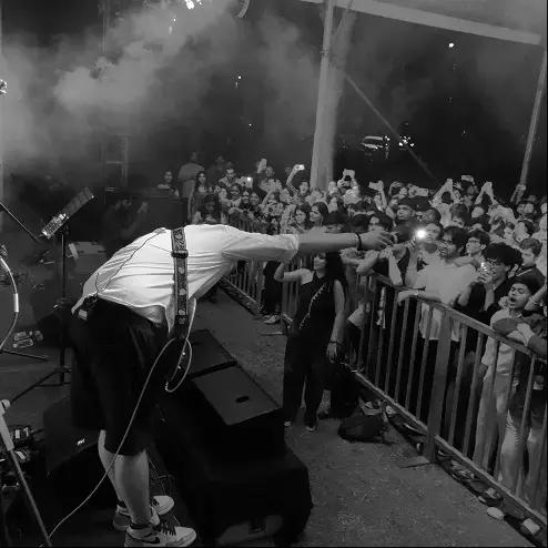 Performer leaning into the crowd at the Mirage fest night stage