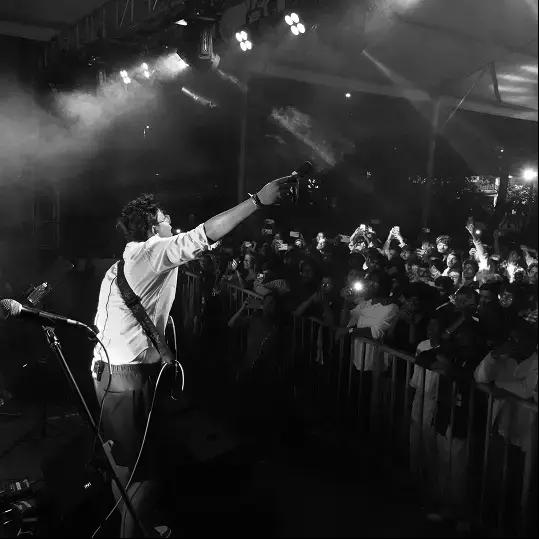 Singer performing under stage lights at Mirage